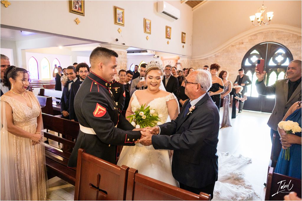Traditional wedding ceremony taking place in a beautifully decorated church with guests.