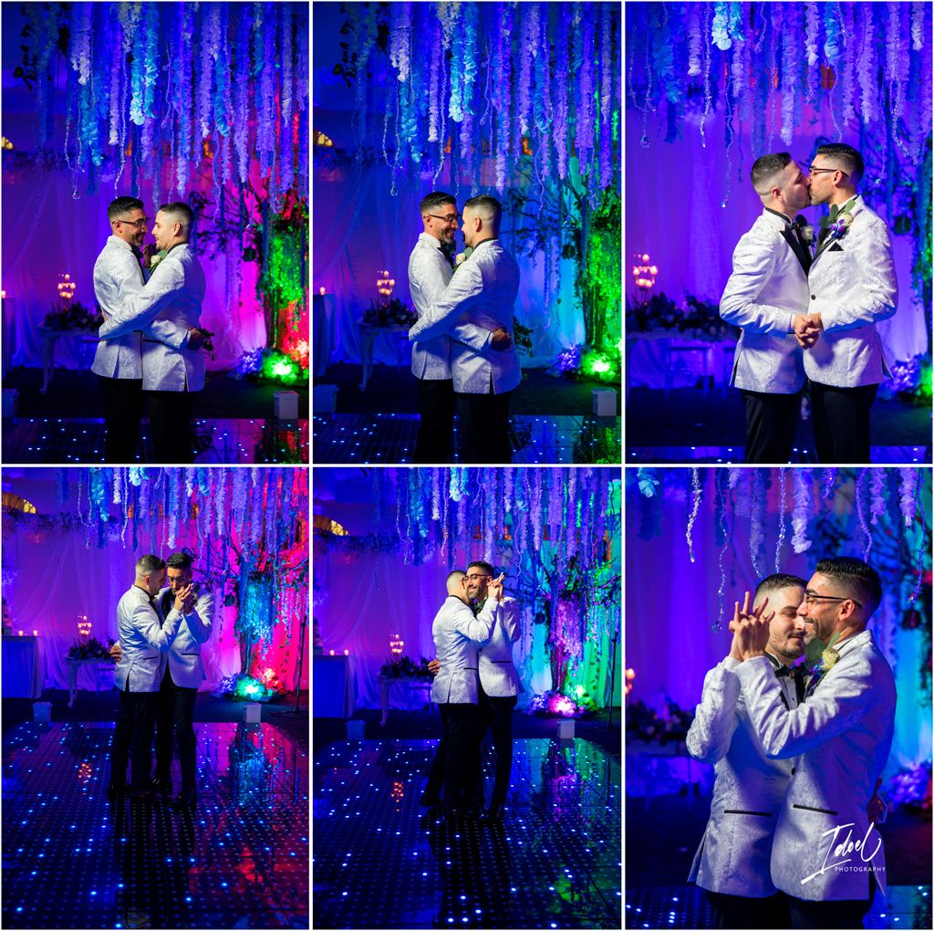 Two people in matching light suits embrace under enchanting blue lighting with illuminated hanging decorations.