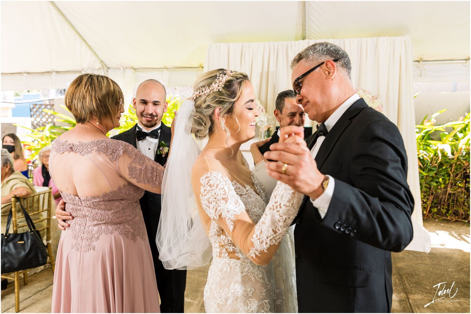 Joyful dance moments captured during wedding reception with guests in formal attire.
