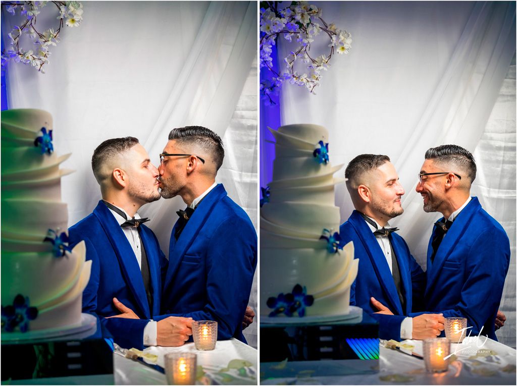 A romantic wedding moment captured of two people in matching royal blue suits sharing a tender kiss during their celebration.
