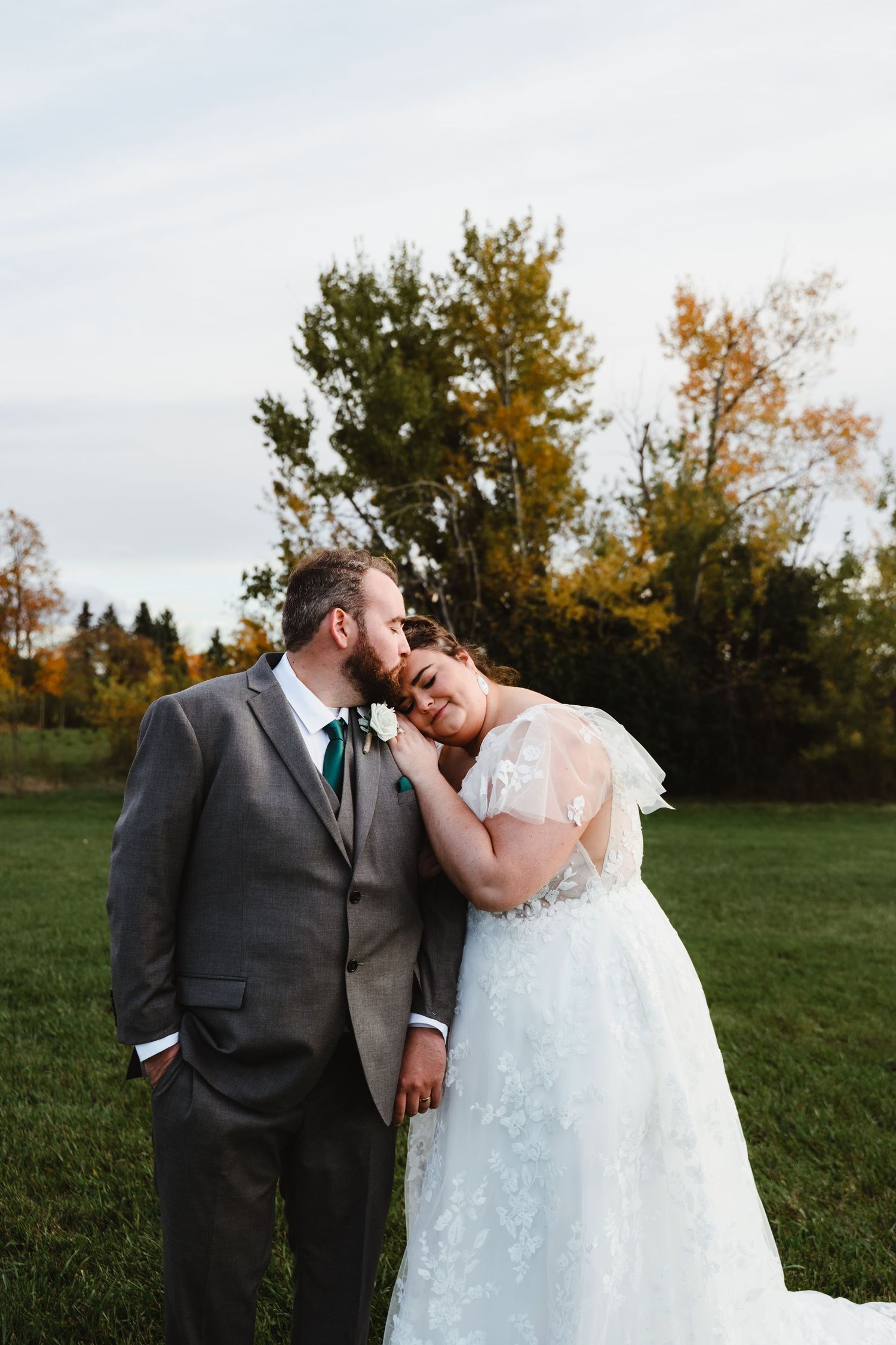 Couple shares intimate moments during outdoor wedding photoshoot.