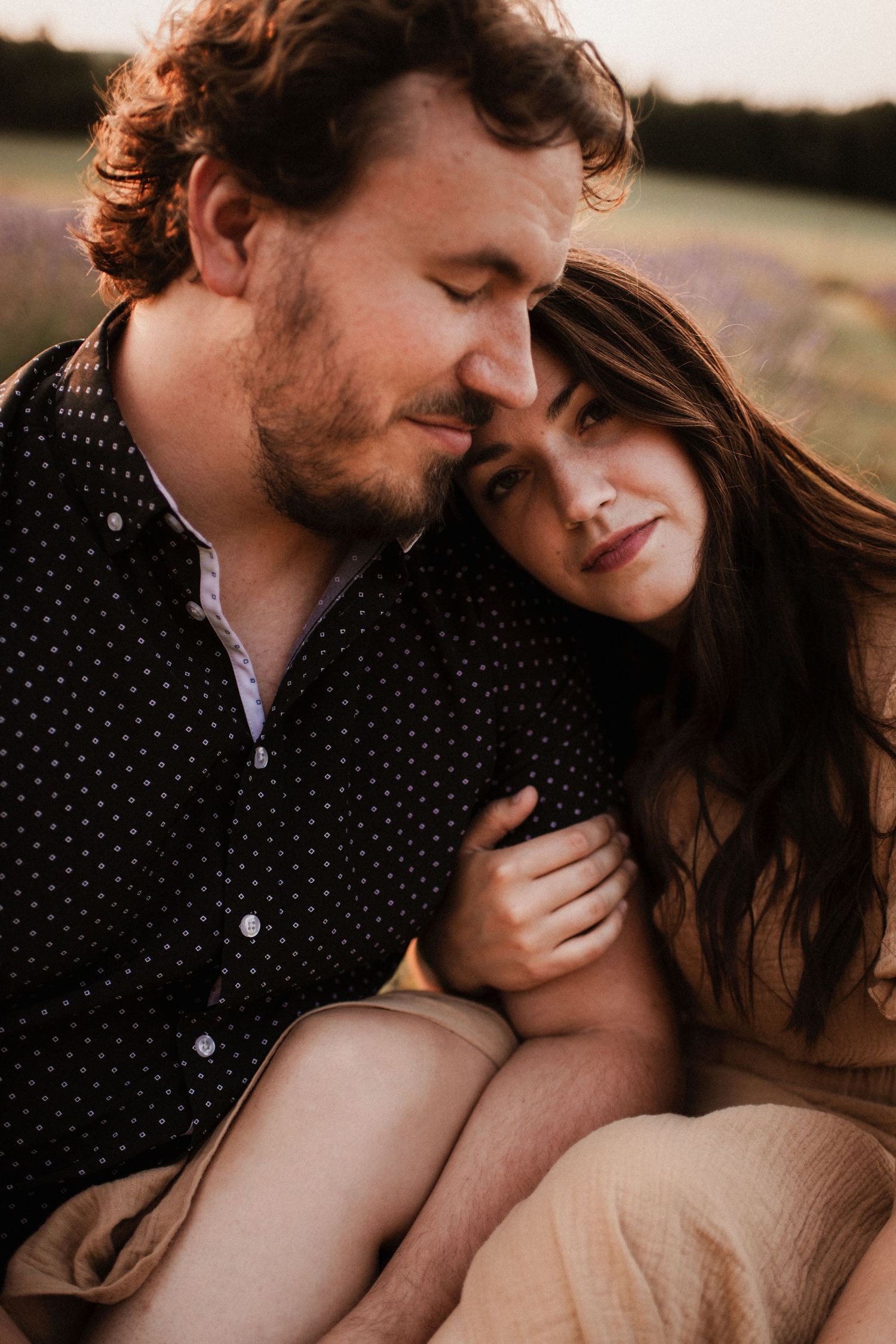 Intimate close-up portrait of couple sharing tender moments outdoors.