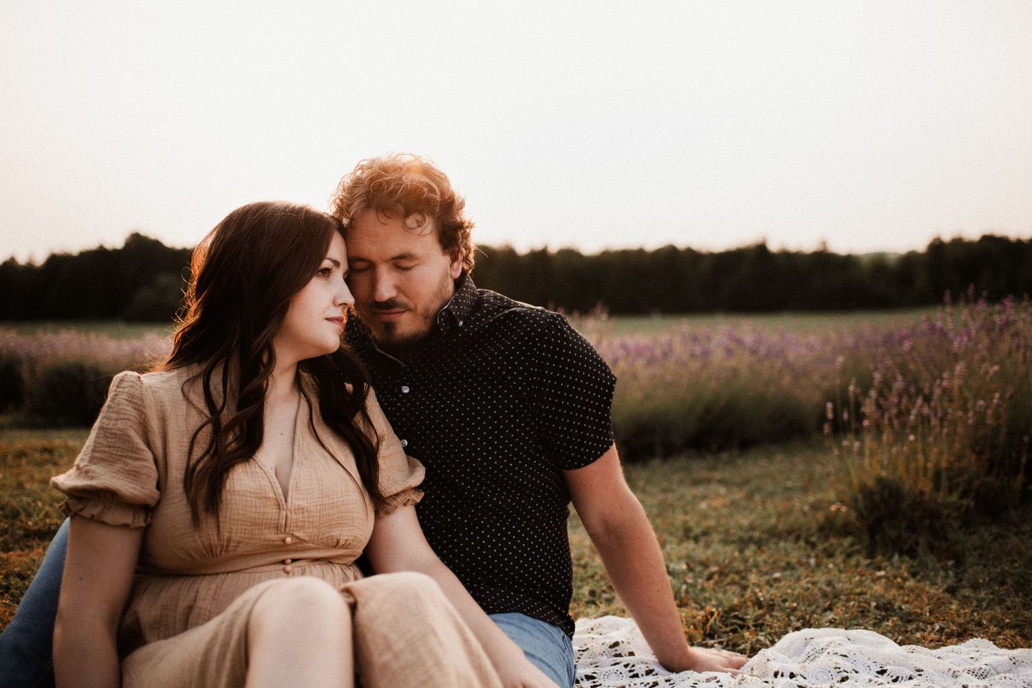 Couple in casual attire sharing romantic moments in a natural setting.