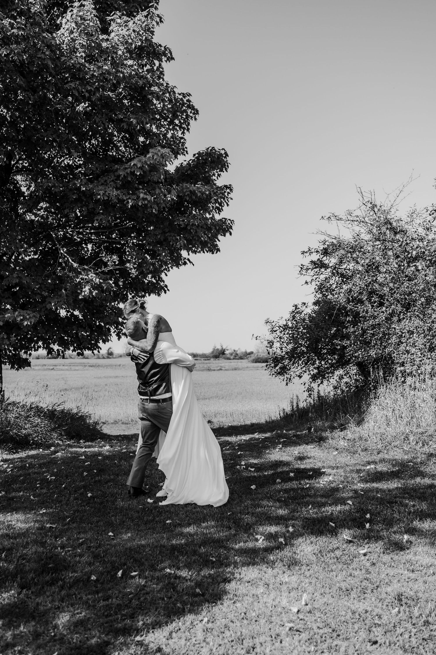 Black and white sequence of couple dancing in natural outdoor setting.