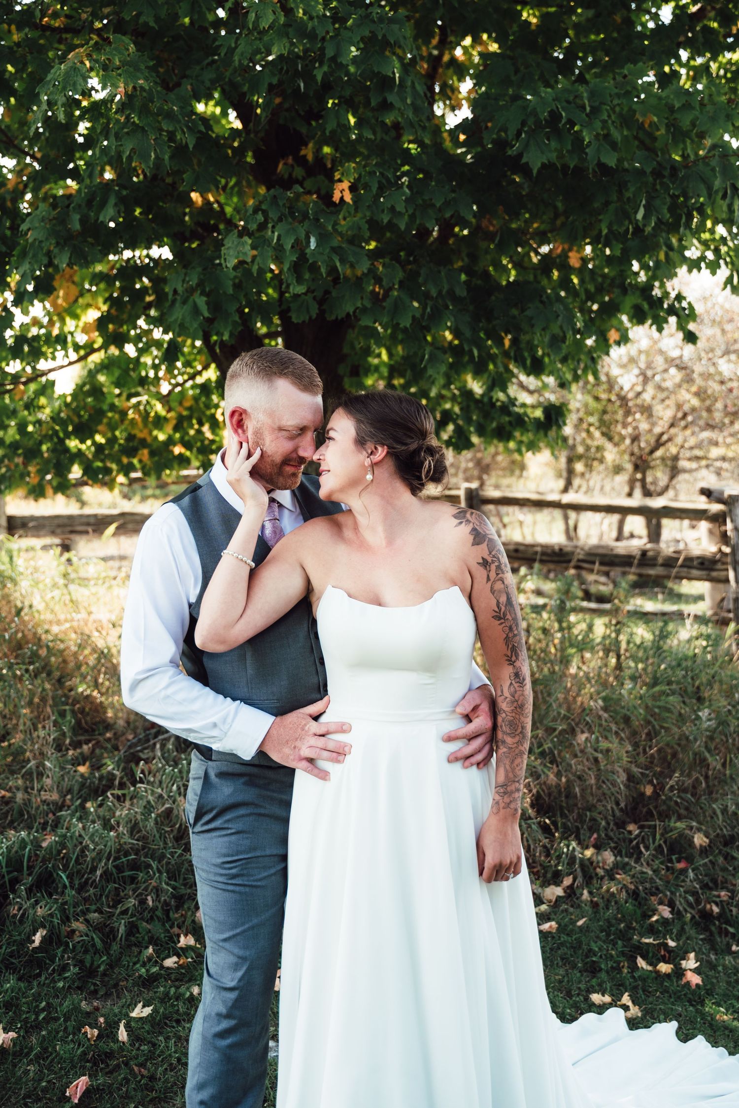 Romantic outdoor wedding portraits showing tender moments between newlyweds.