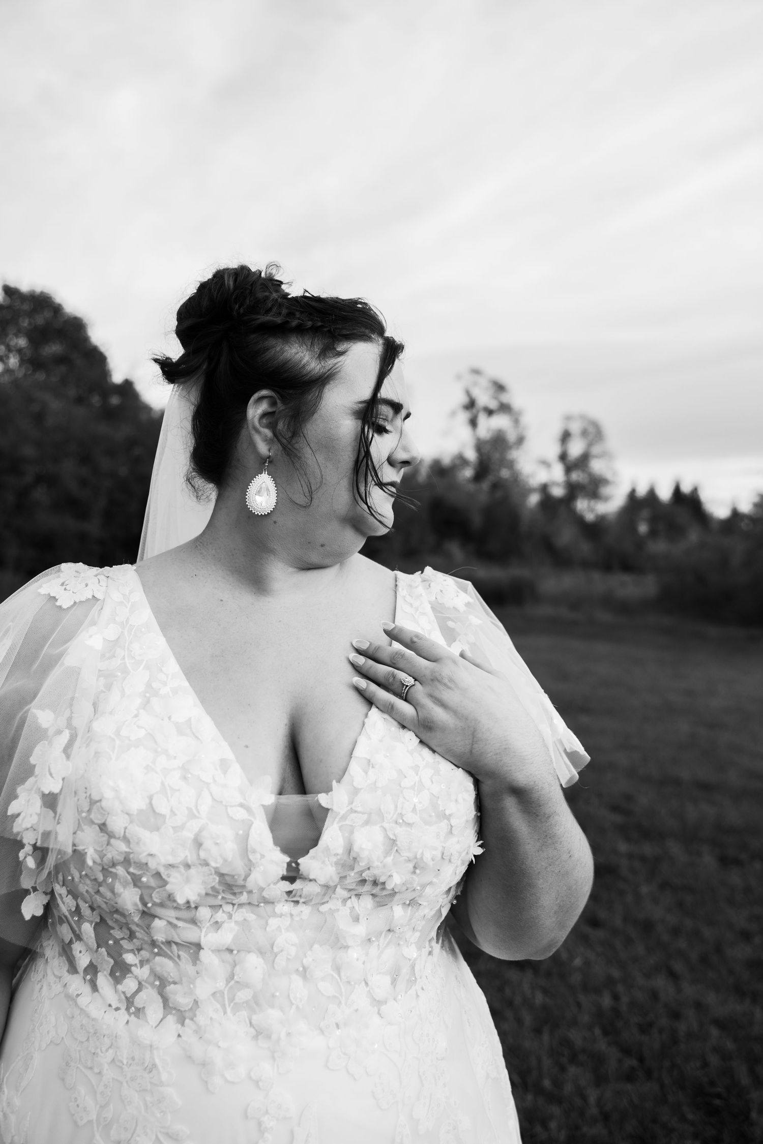 Close-up details of a delicate white lace wedding dress bodice with floral appliques.