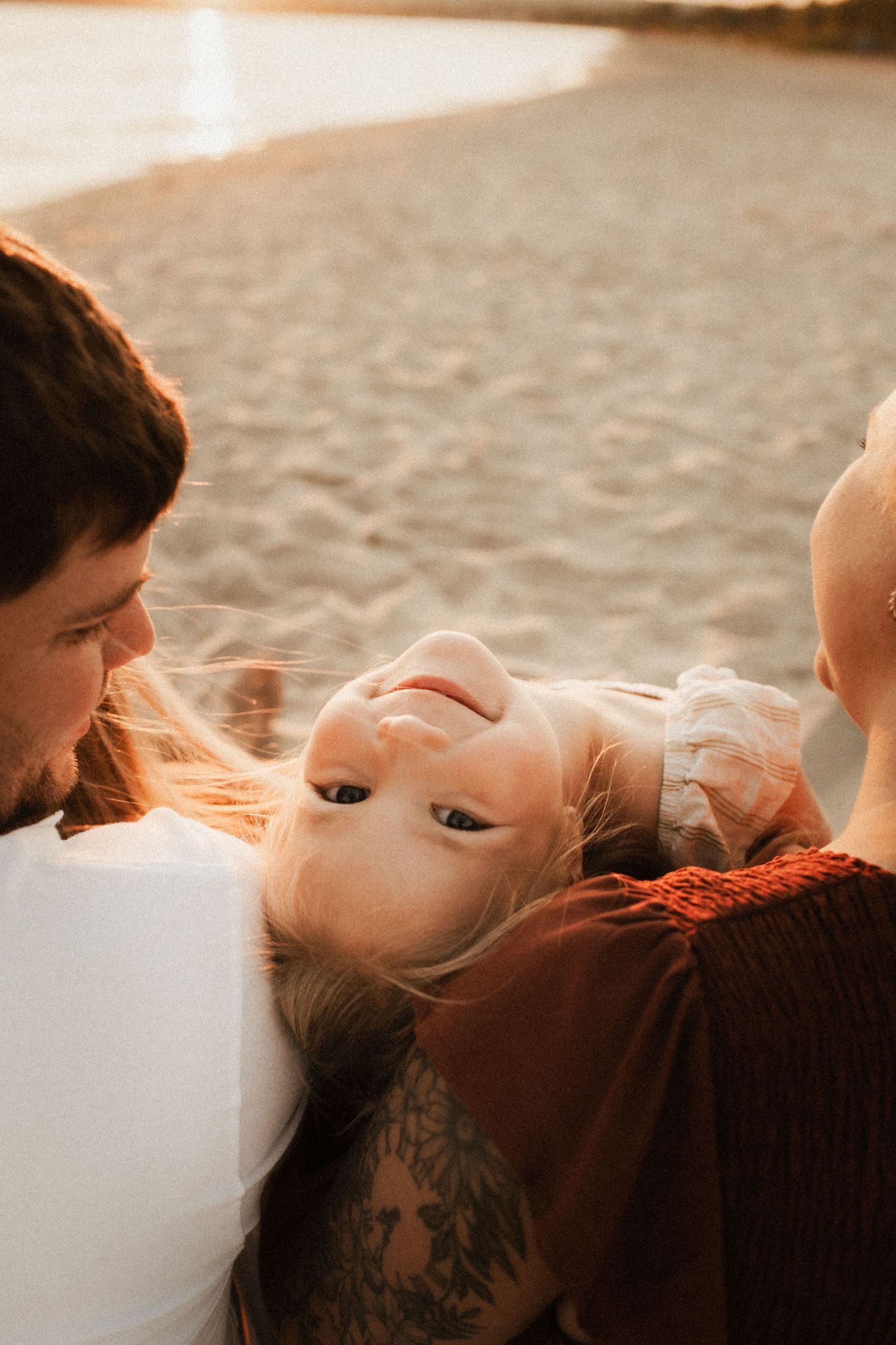 Intimate close-up portrait with soft lighting and gentle expressions at sunset.