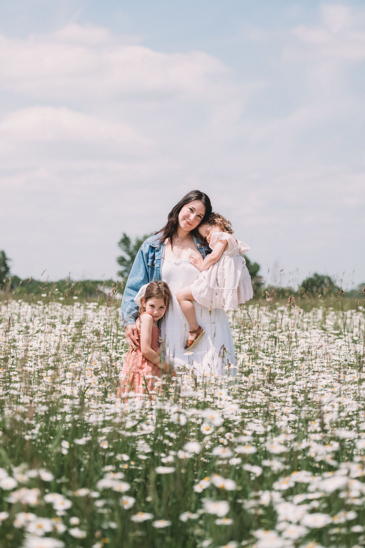 People sharing tender moments in a field of white daisies.