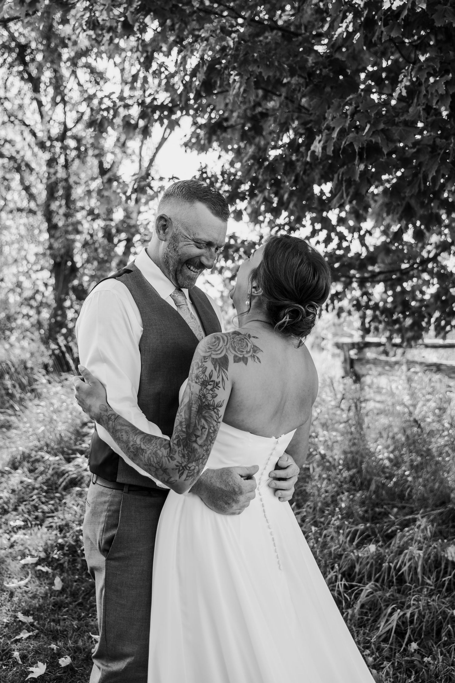 Black and white photos of couple embracing outdoors during wedding portraits.
