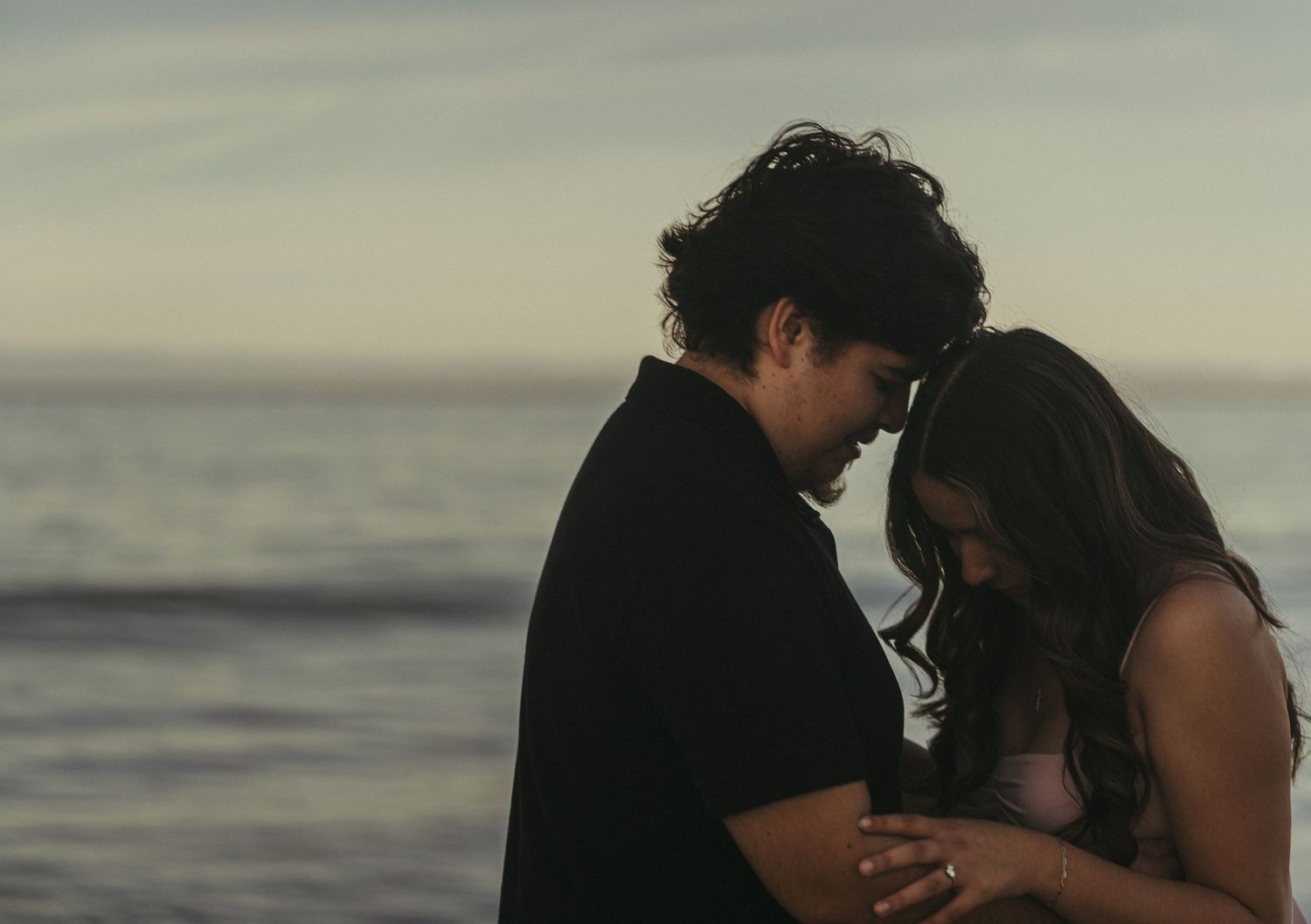 Romantic beach engagement photos captured in Monterey, California by a Central Valley couples photographer specializing in candid,