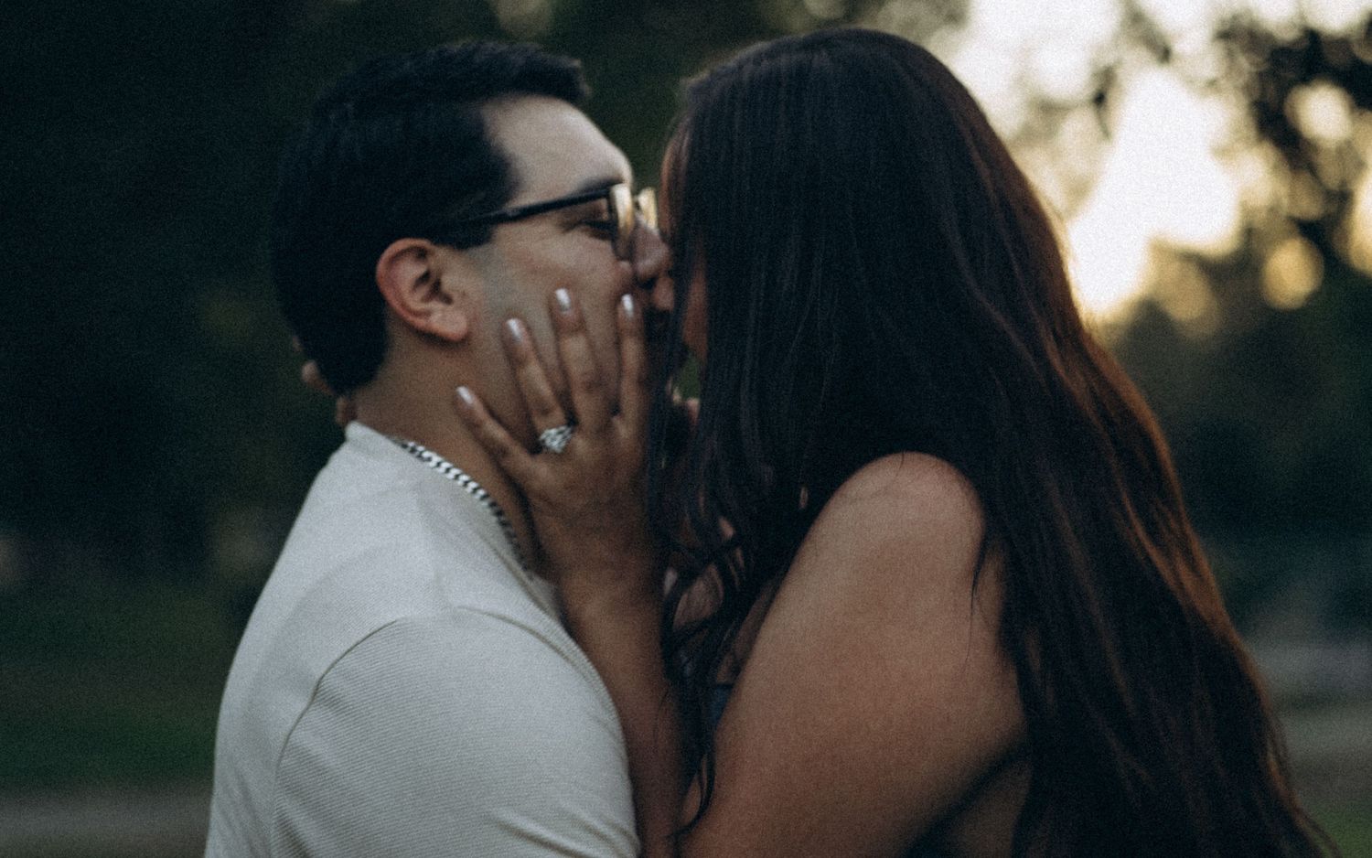 Couple embracing at sunset during an couples photo session in madera, California.