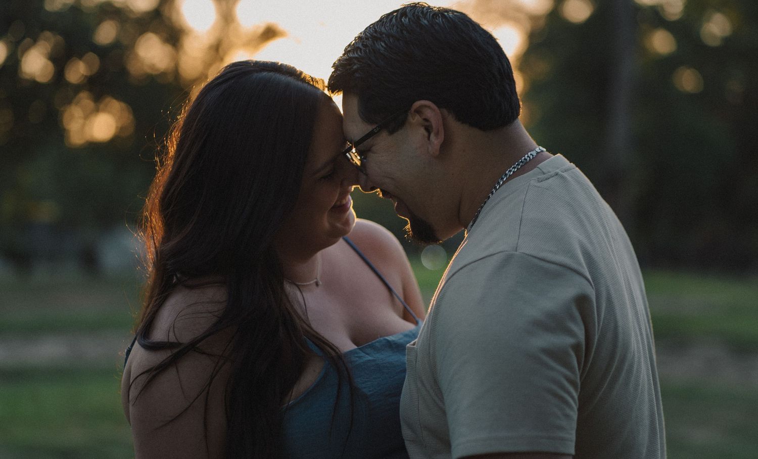 Couple embracing at sunset during an engagement session in Fresno, California.