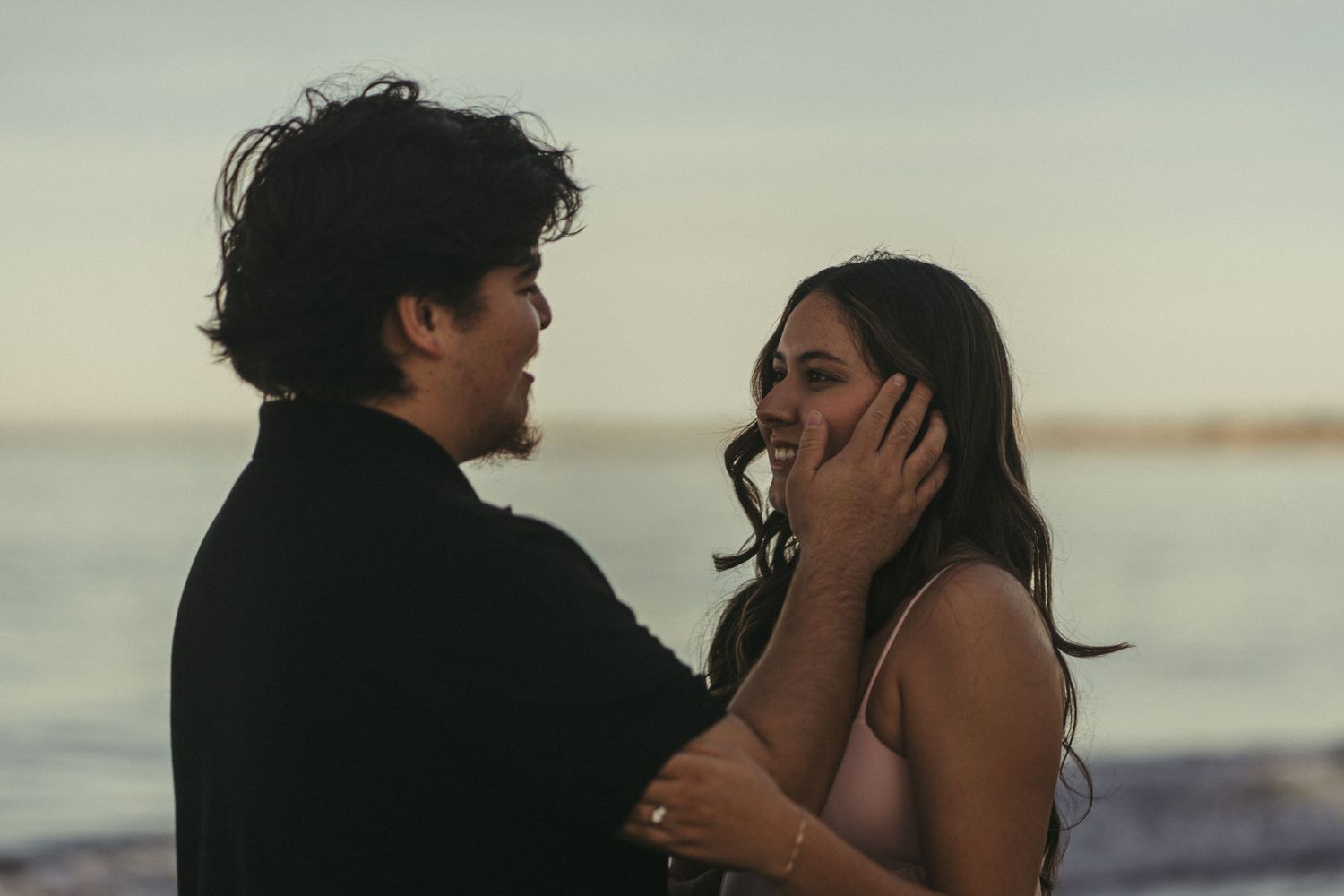 Couple embracing at beach in monterey