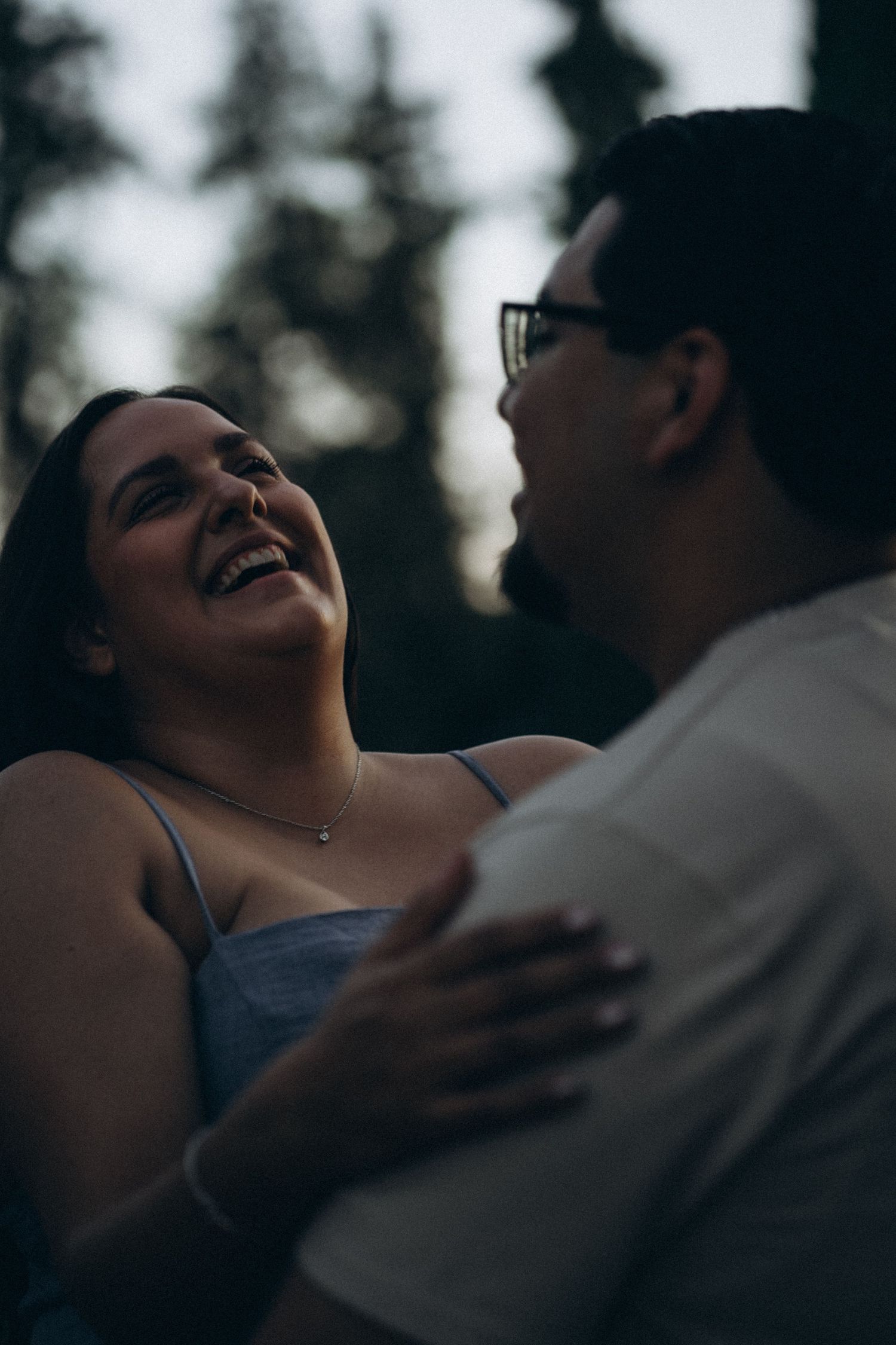 Couple laughing during their engagement session.