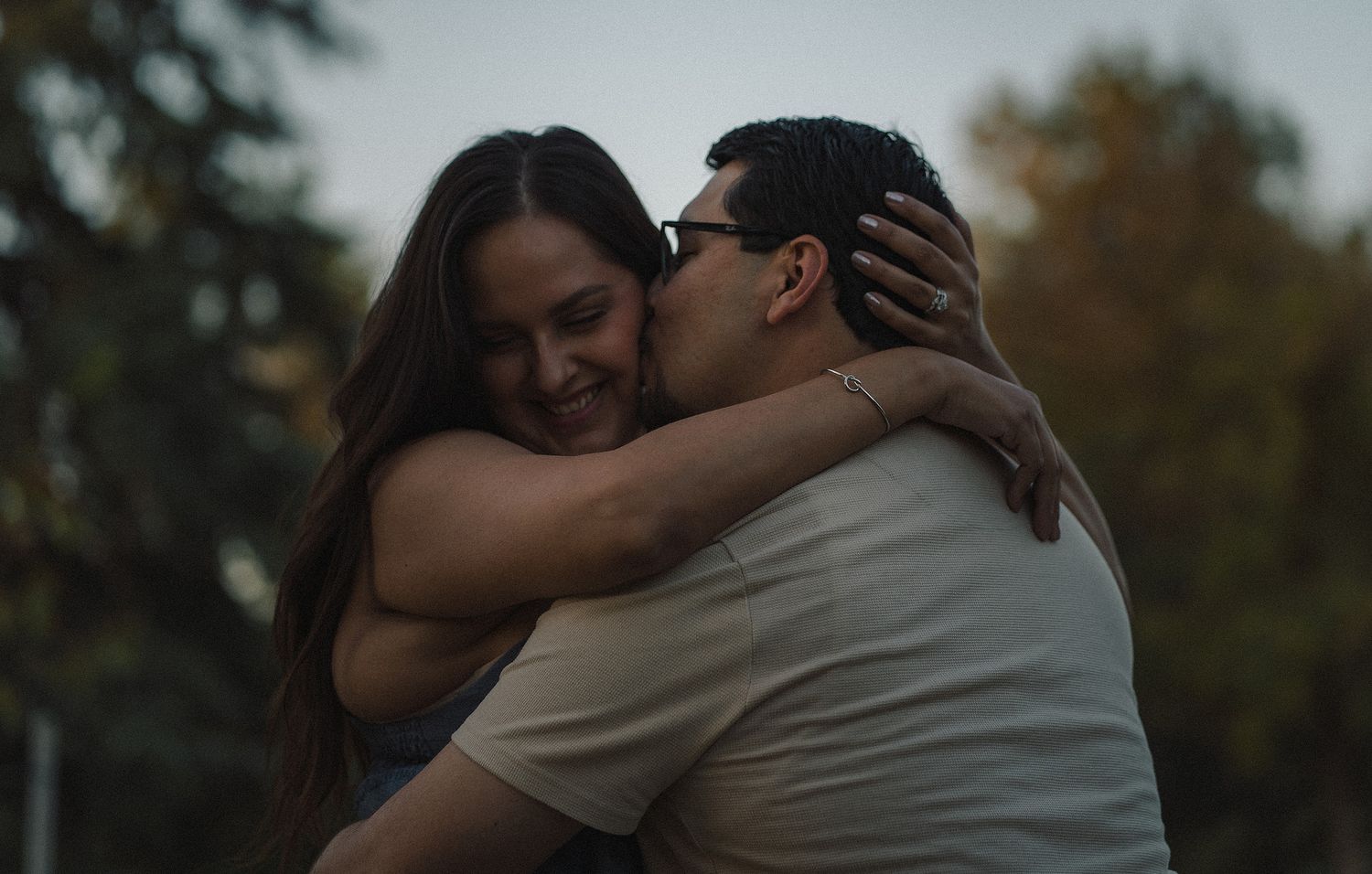 Couple holding each other happy during an engagement session in Madera, California.