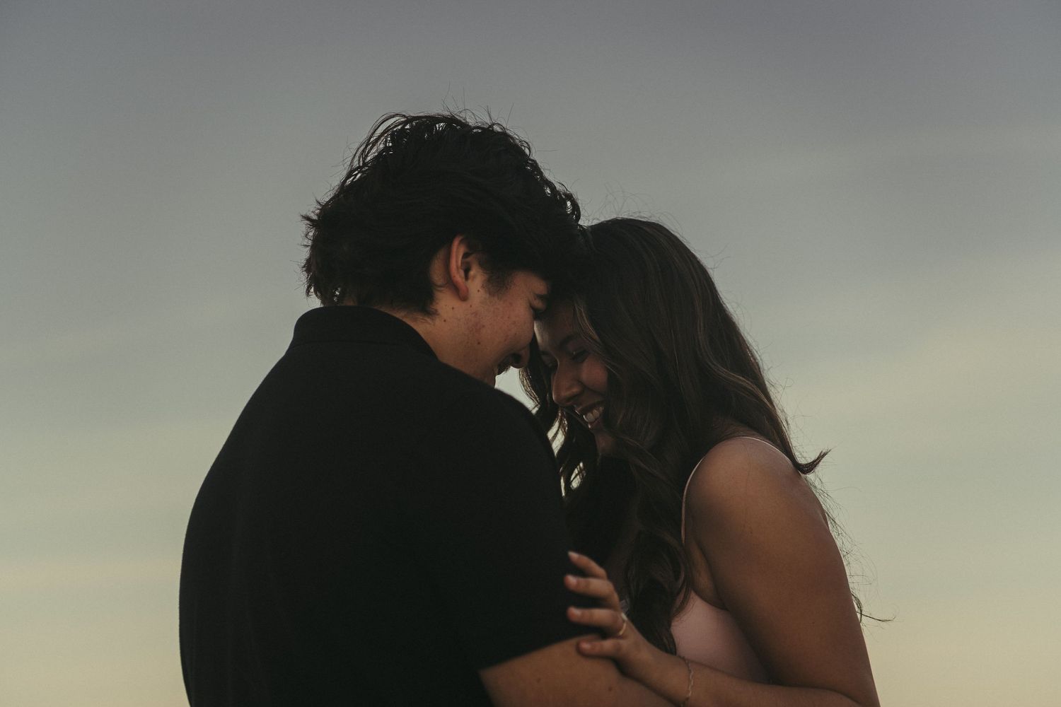 Romantic beach engagement photos captured in Fresno, California by a Central Valley couples photographer