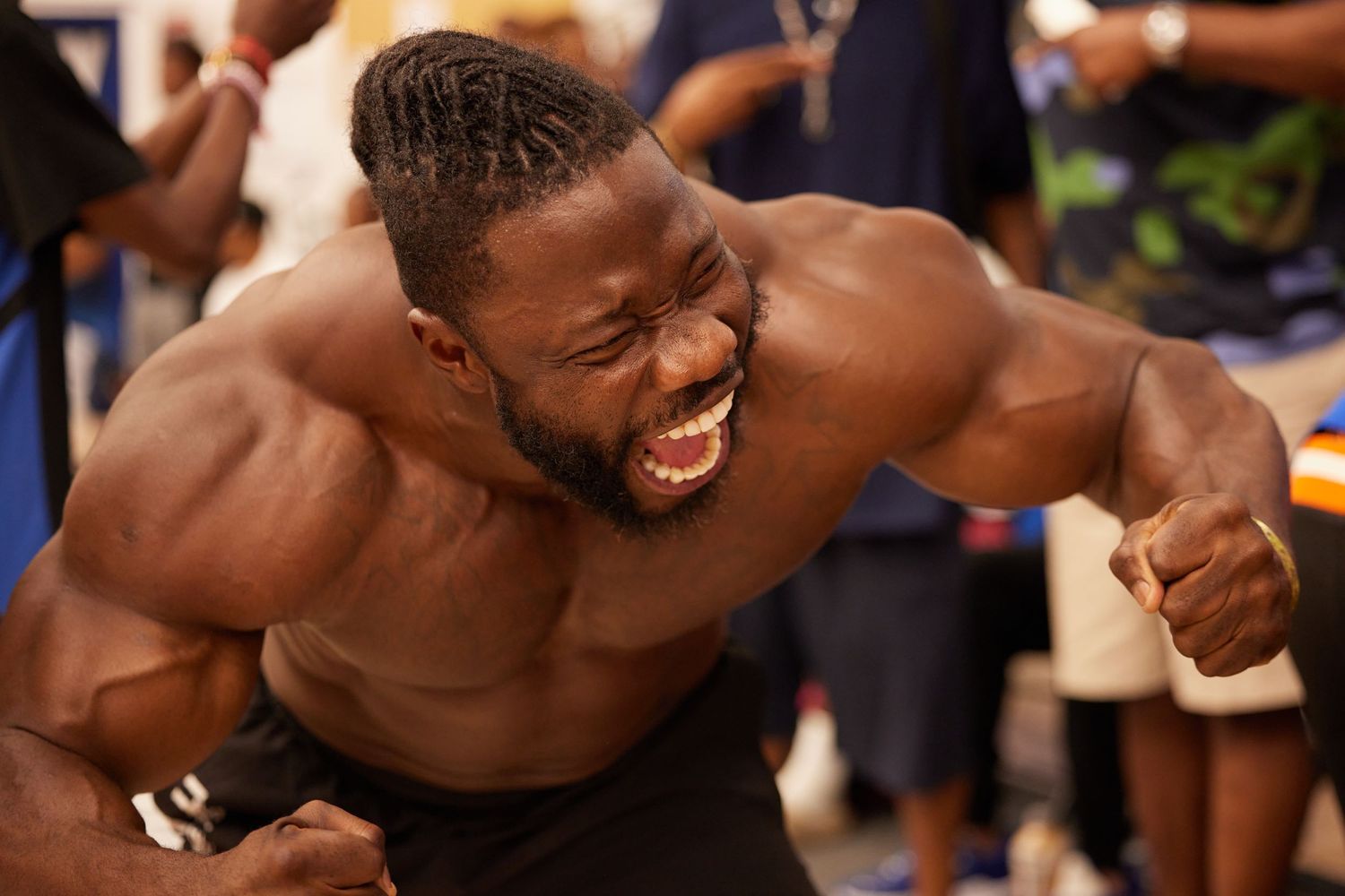Athlete flexing in competitive moment at Ballin4Peace basketball event at John Jay College