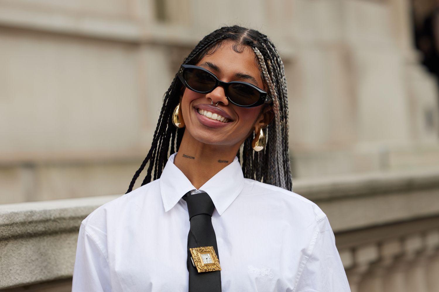 Fashion model with braids and sunglasses at New York Fashion Week street style portrait
