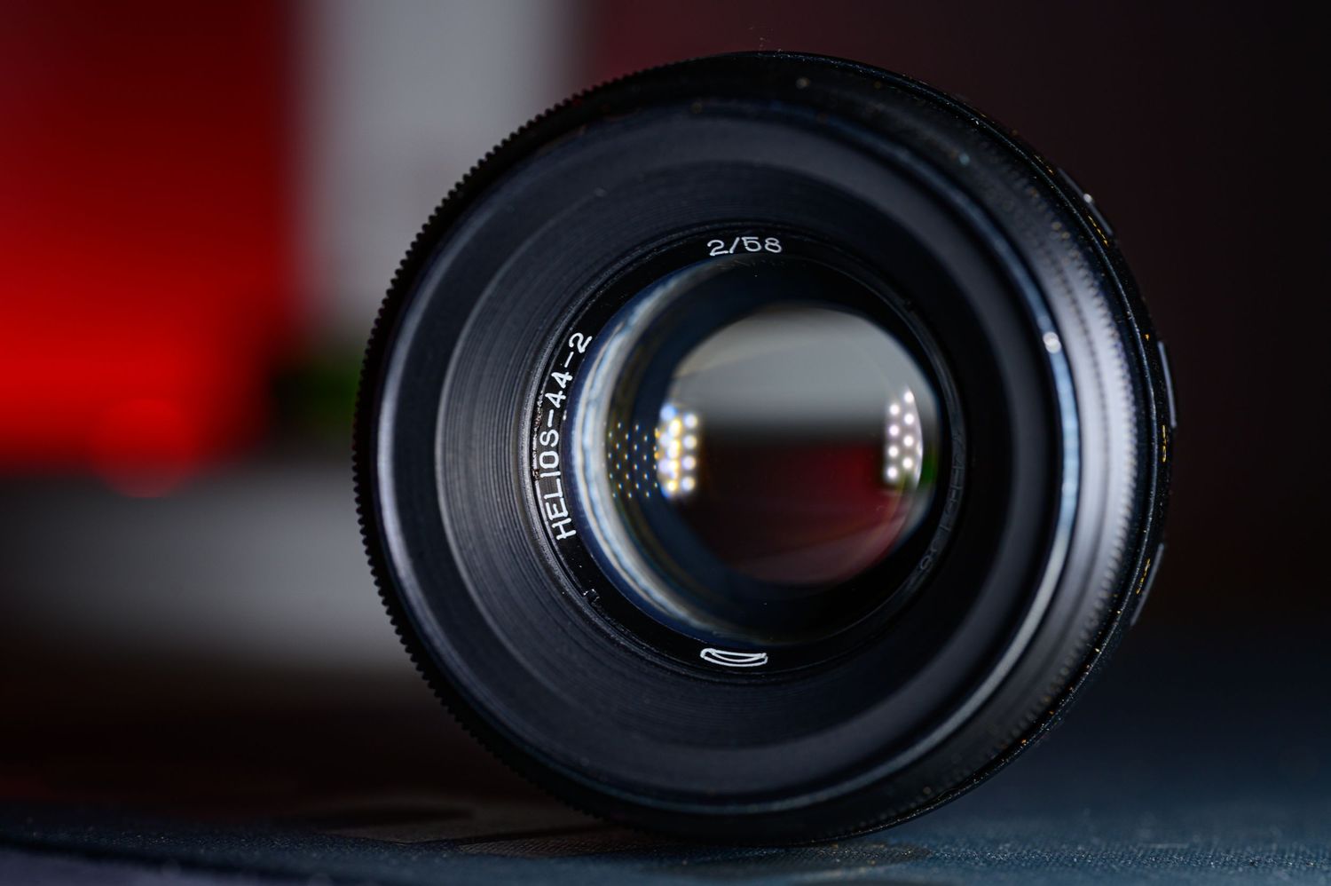 Close-up front view of a black 70-200mm camera lens with reflective glass element.
