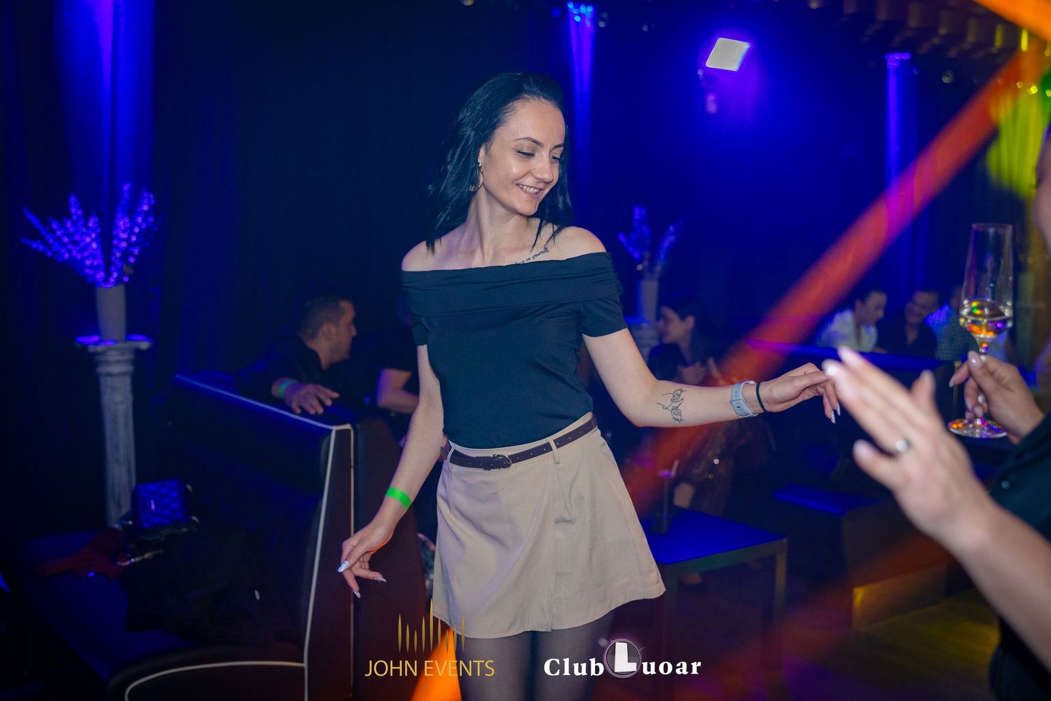 Eine Frau mit schwarzem Oberteil und beigem Rock tanzt im Club Luoar.