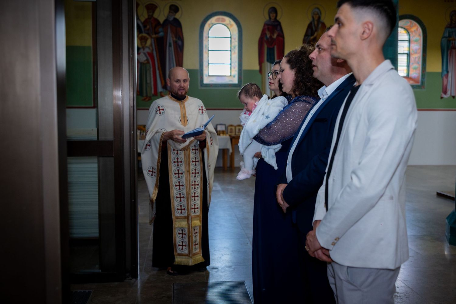 Familie und Gäste stehen gemeinsam am Kircheneingang