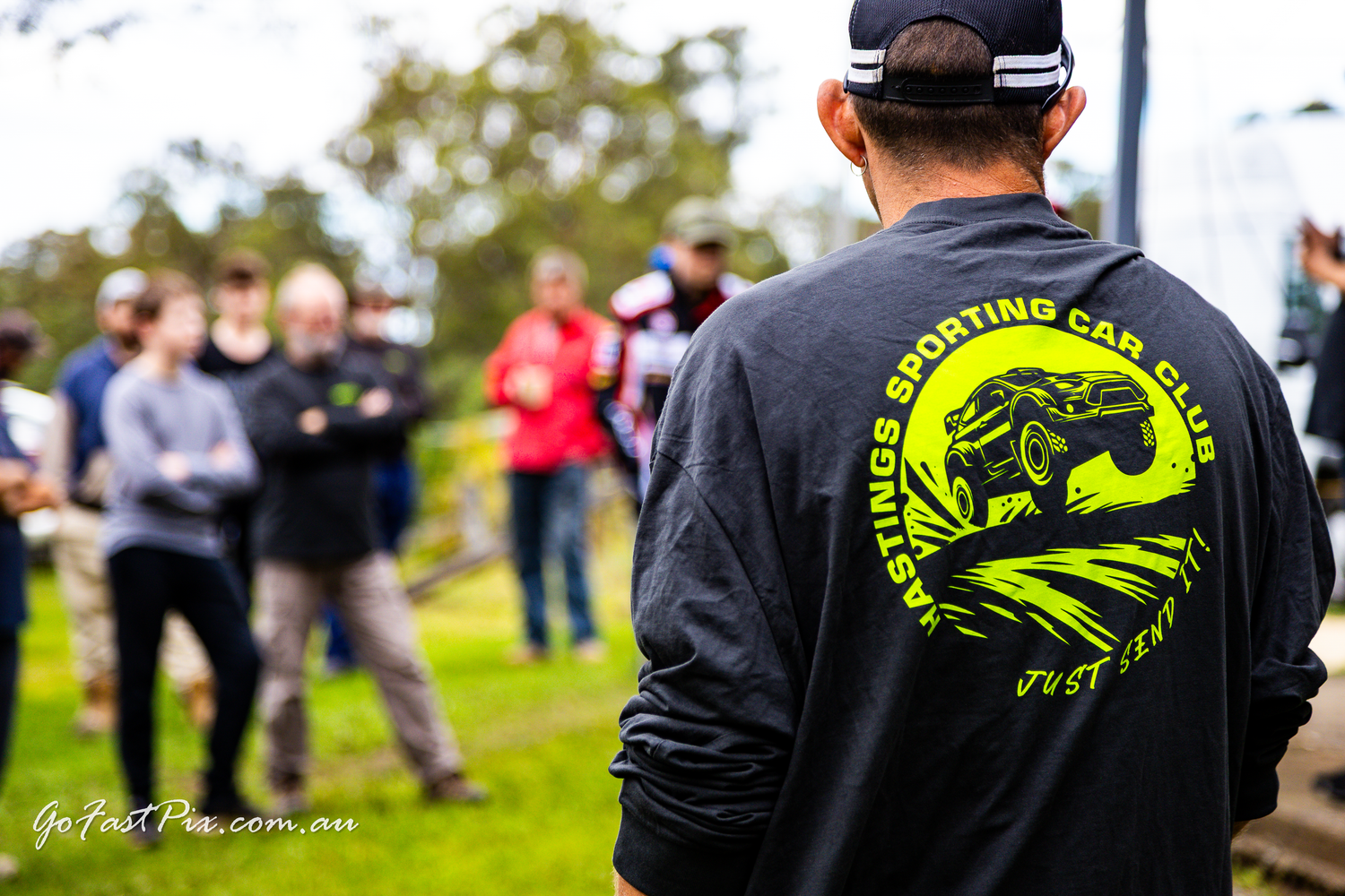 Person wearing Hastings Sporting Car Club black shirt at an outdoor motorsport event.