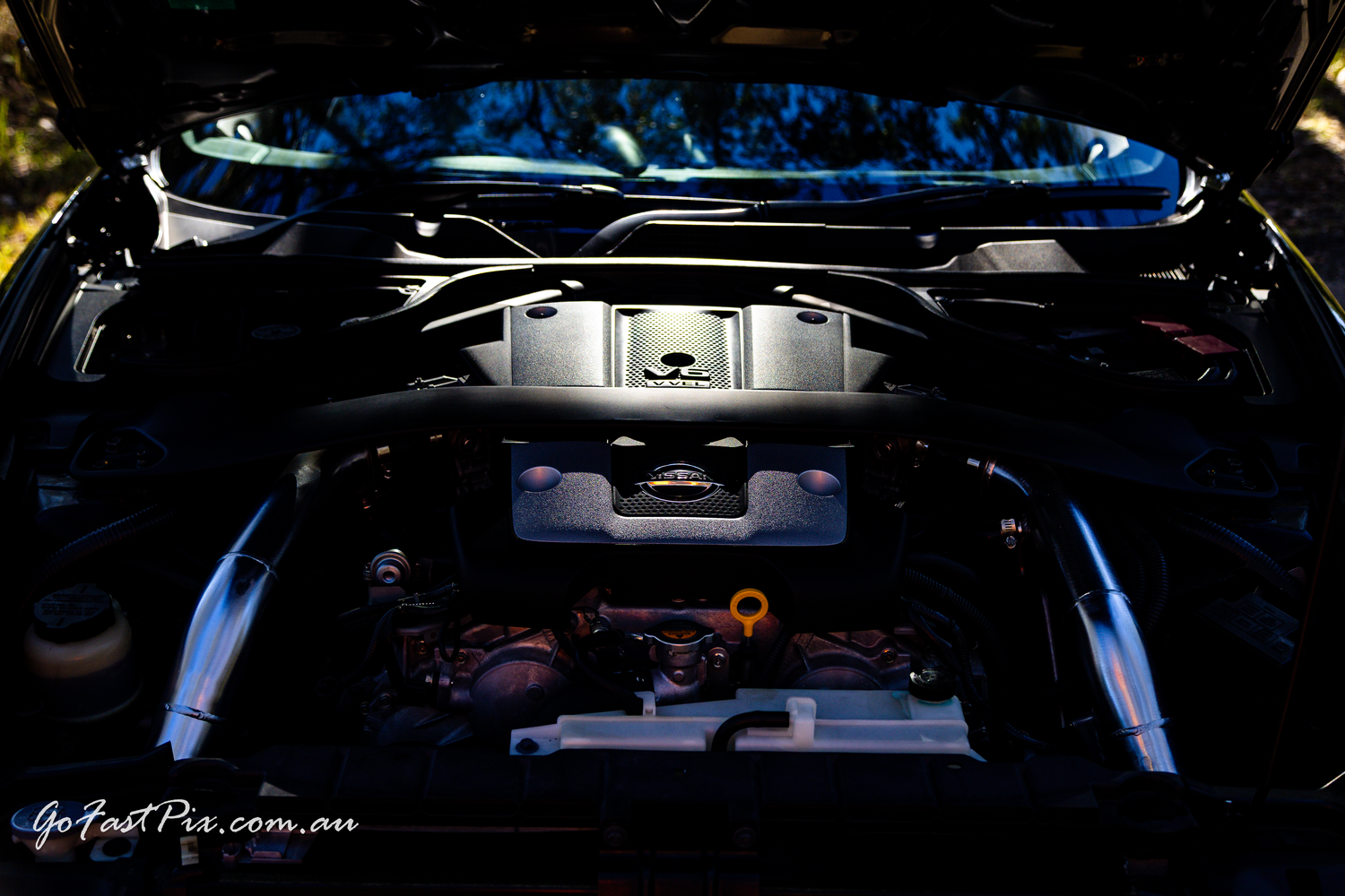 Clean engine bay of modified sports car with aftermarket performance parts.