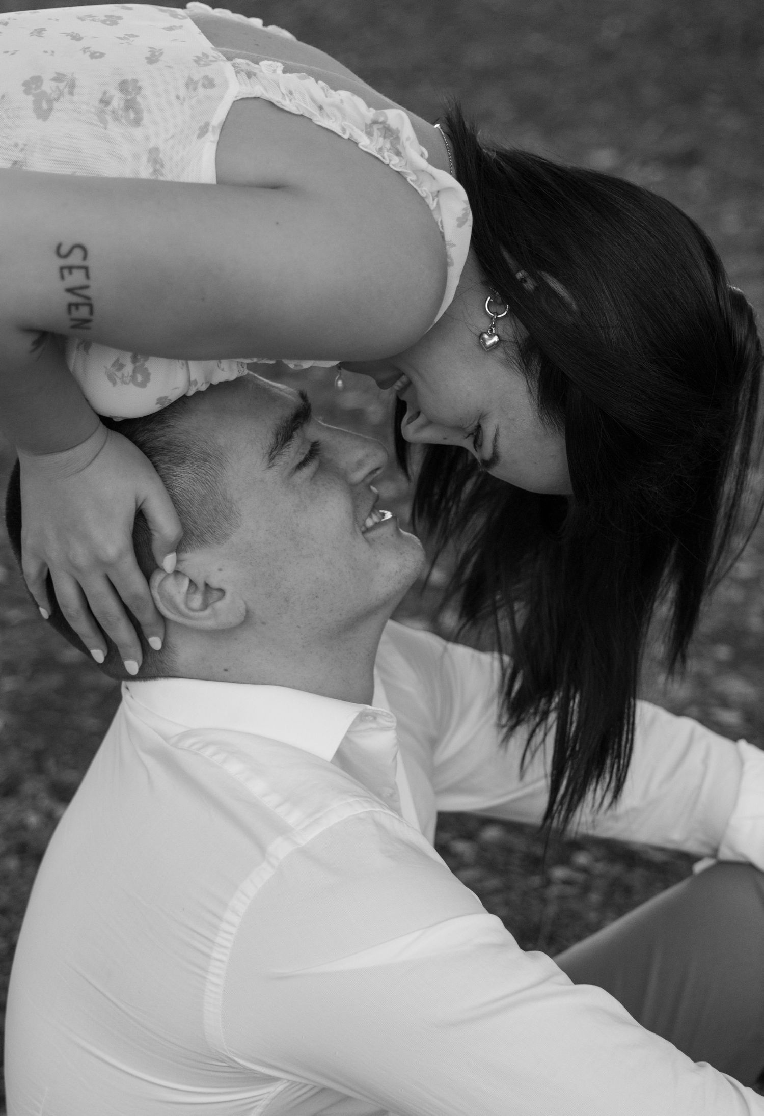 Black and white romantic photo of a couple kissing in an outdoor setting. Stephenville Texas Photographer