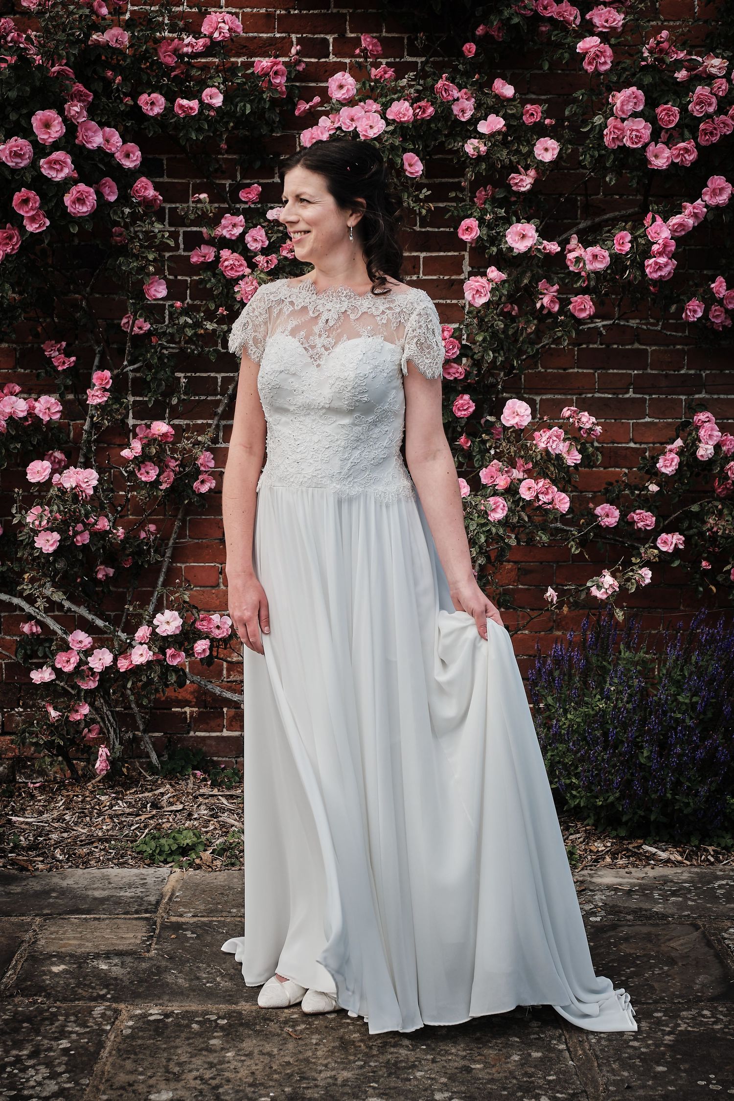 Elegant white wedding gown with lace details and flowing skirt photographed in Surrey by great value Surrey Wedding PHotographer
