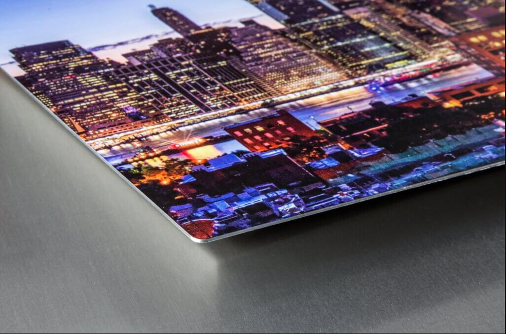 Vibrant cityscape panorama at night with illuminated buildings and streets creating a glowing urban landscape.