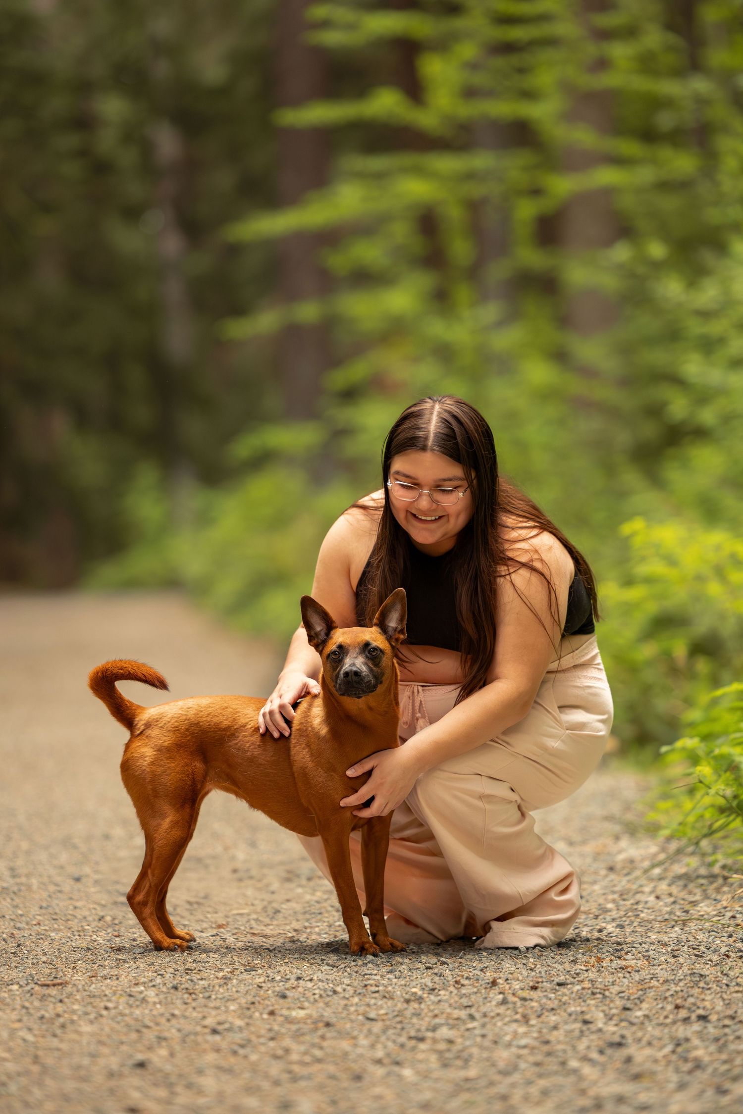 Dog and owner photographed outdoors in forest setting