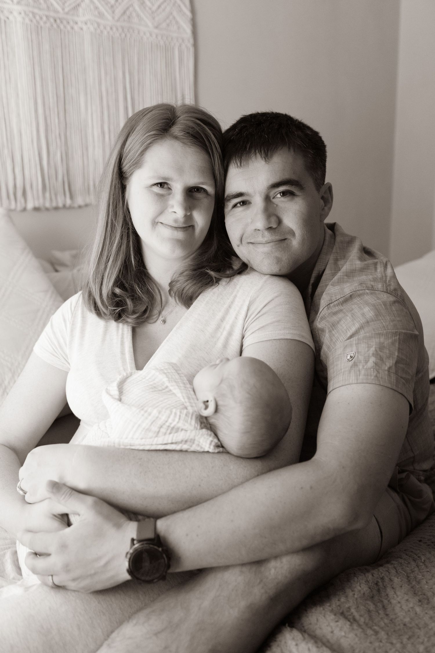 Black and white photograph of a new family with their newborn baby at their in-home photo session with Bay Area Newborn Photographer