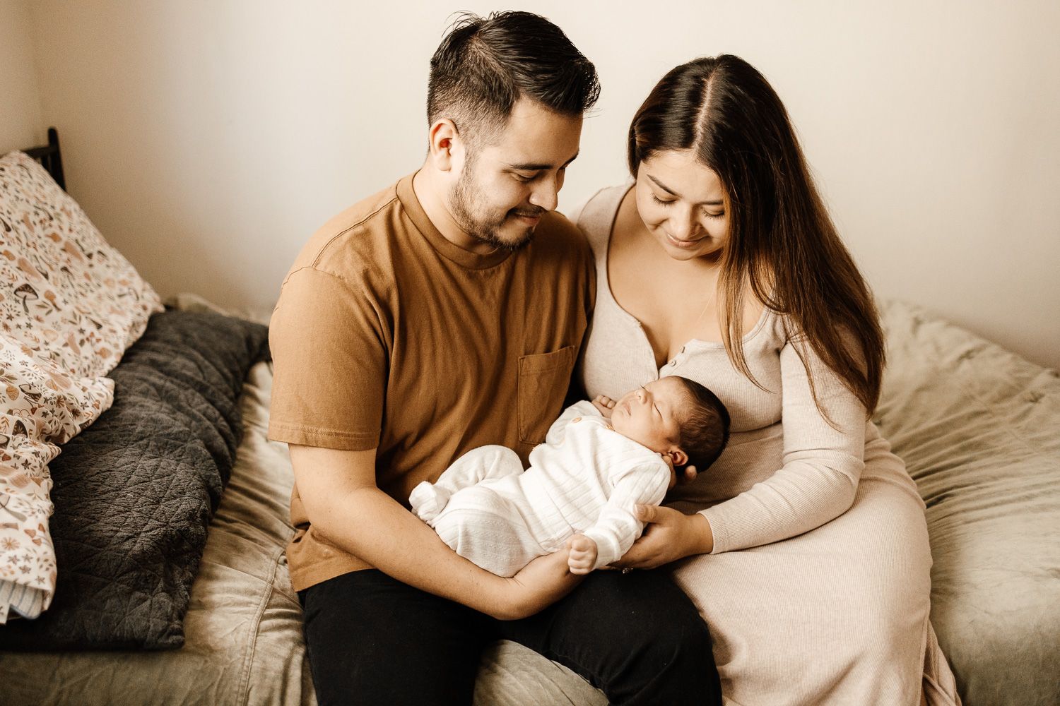 Parents smile at their new baby during newborn photo session in San Jose with Bay Area Photographer Cindy Tucey