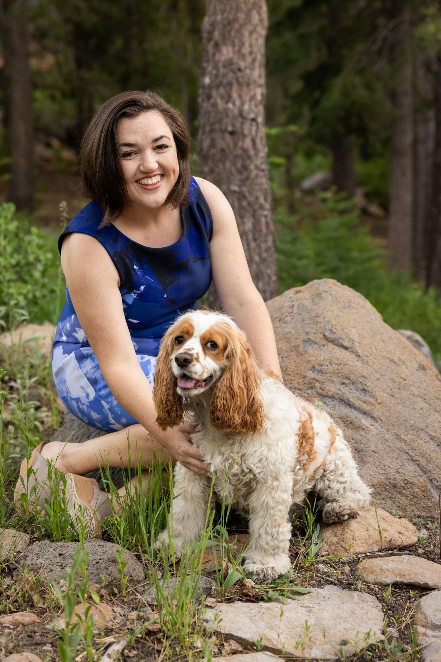 Woman pets dog in outdoor setting