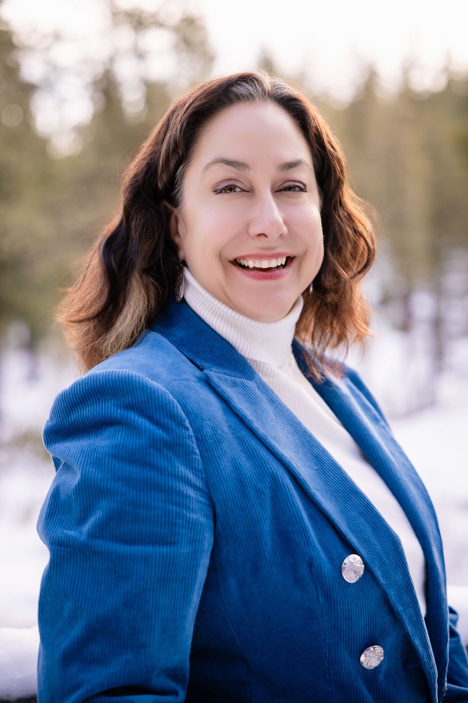 Portrait of woman in front of snow with trees in Truckee