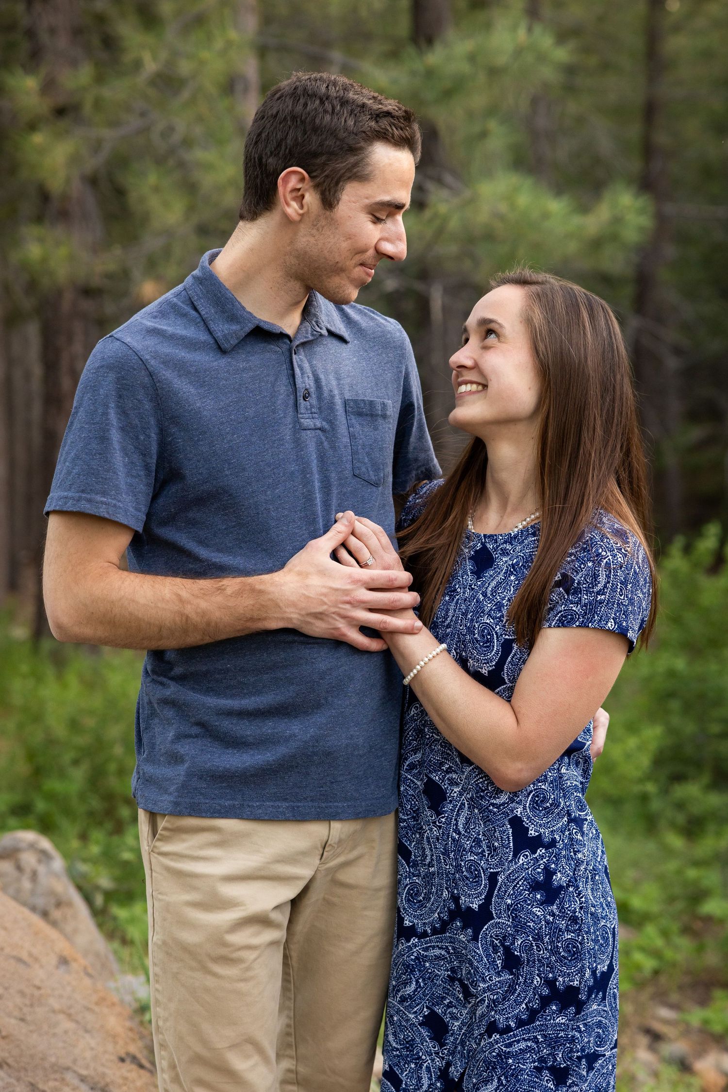 Couple smile with trees behind them in Truckee