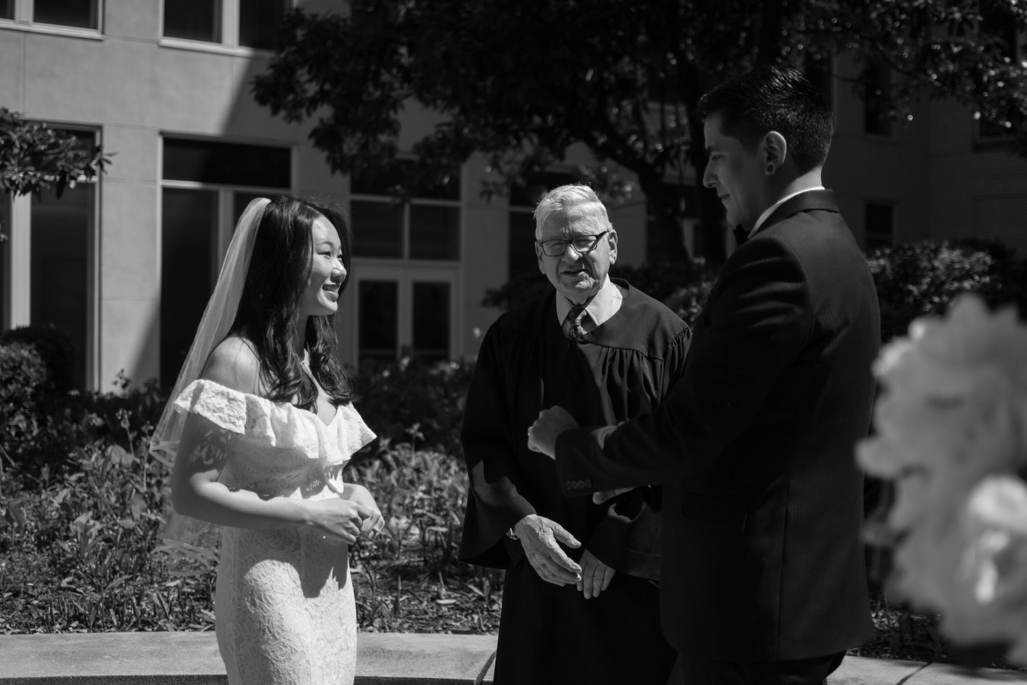 A series of black and white wedding photos showing couples and guests celebrating at an outdoor ceremony.