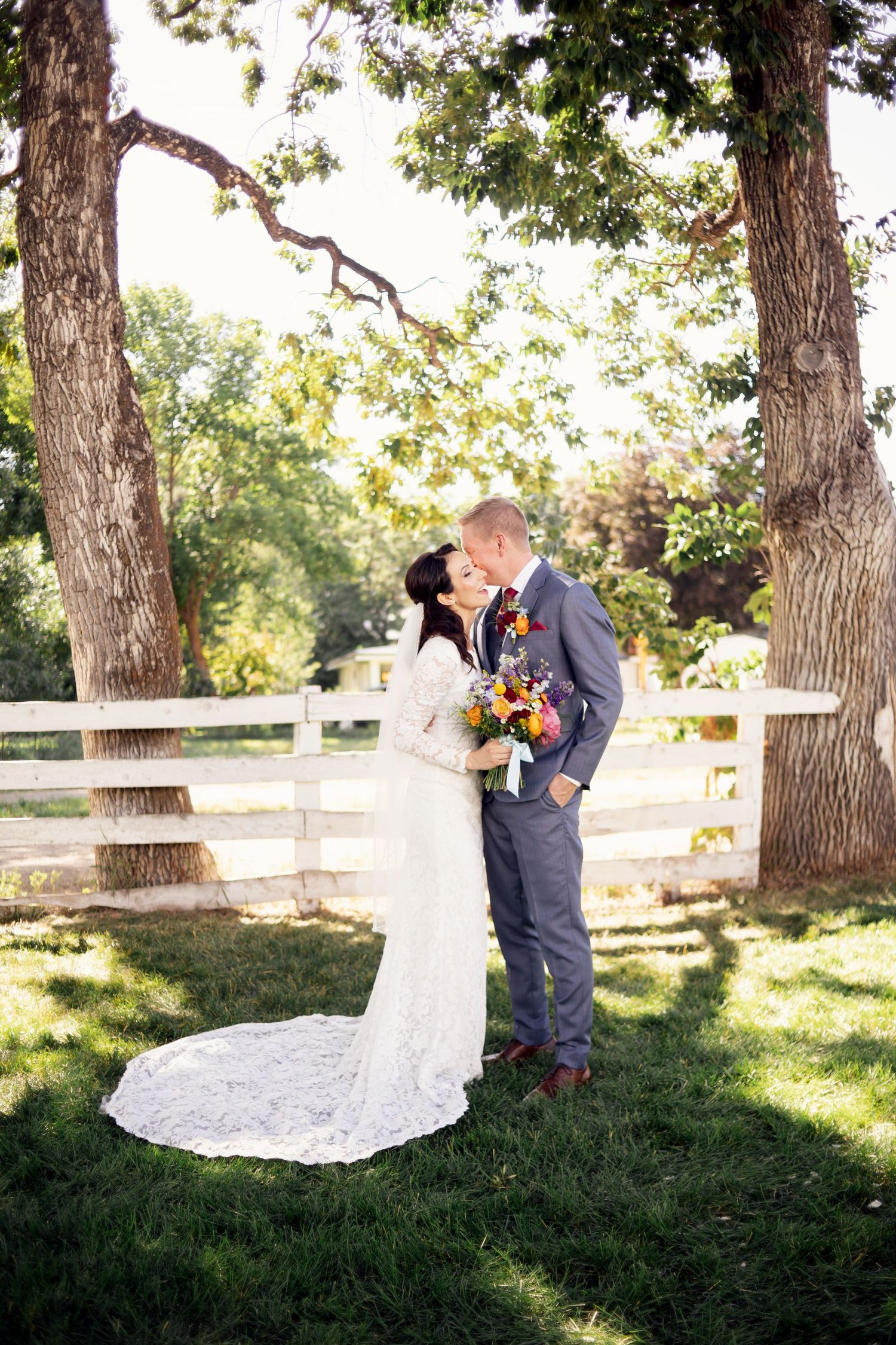 bride and groom embracing at traditional outdoor kansas city wedding