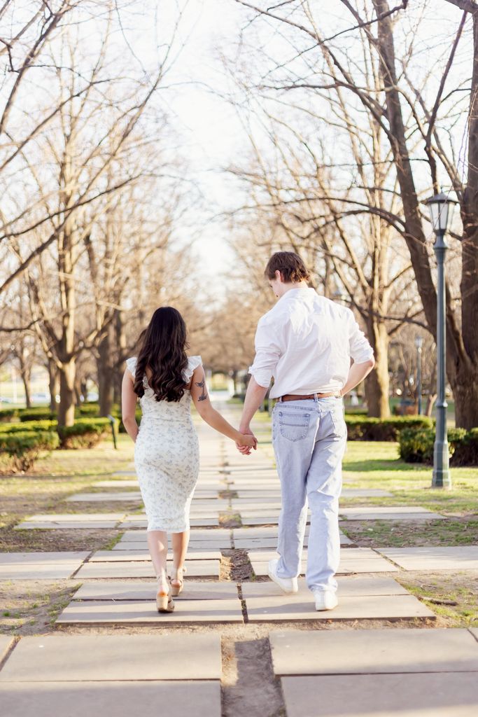 Happy couple walking outside of the Nelson-Atkins Museum of Art in KCMO