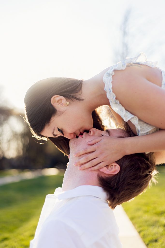 boyfriend and girlfriend doing a spiderman style kiss
