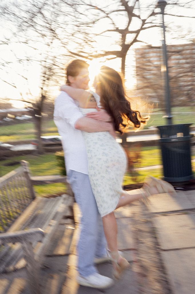 happy couple spinning on the grounds of the  Nelson-Atkins Museum of Art in Missouri