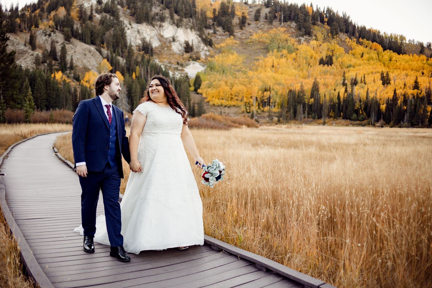 joyful couple walking and talking in the fall photographed by missouri wedding photographer