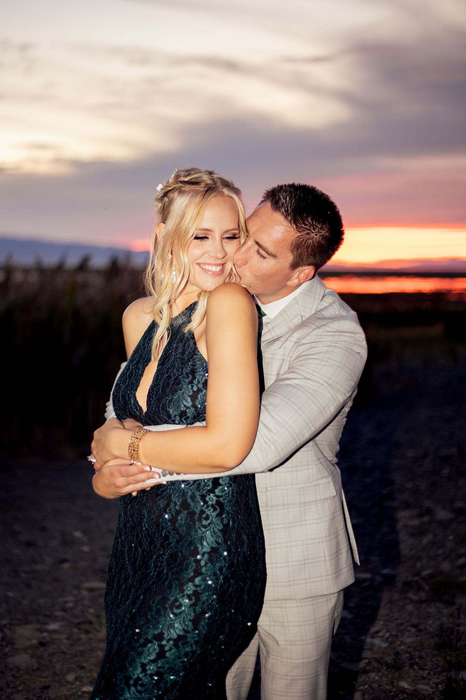 couple hugging in unique dress at missouri sunset elopement