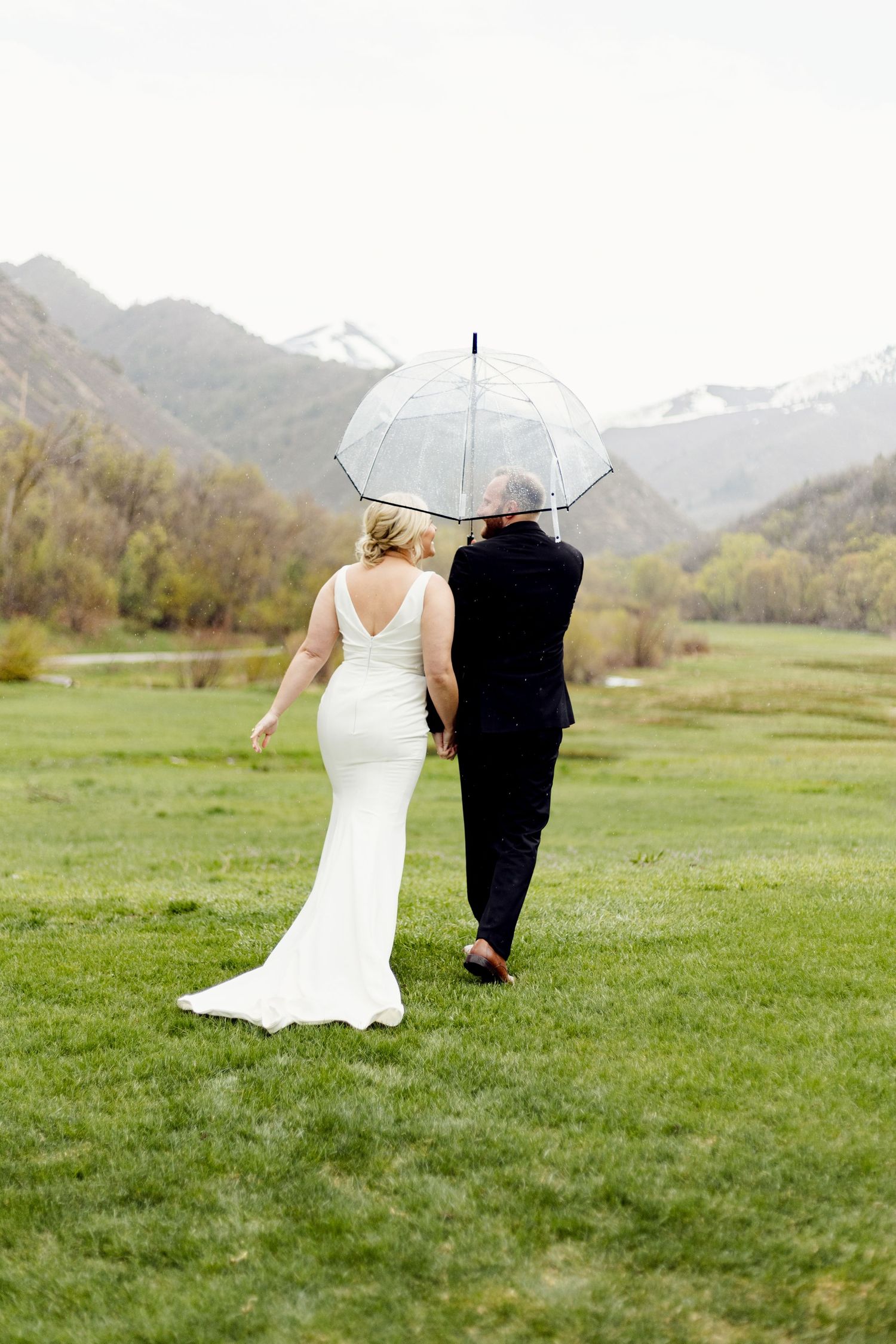 timeless wedding portrait of missouri bride and groom walking in the rain