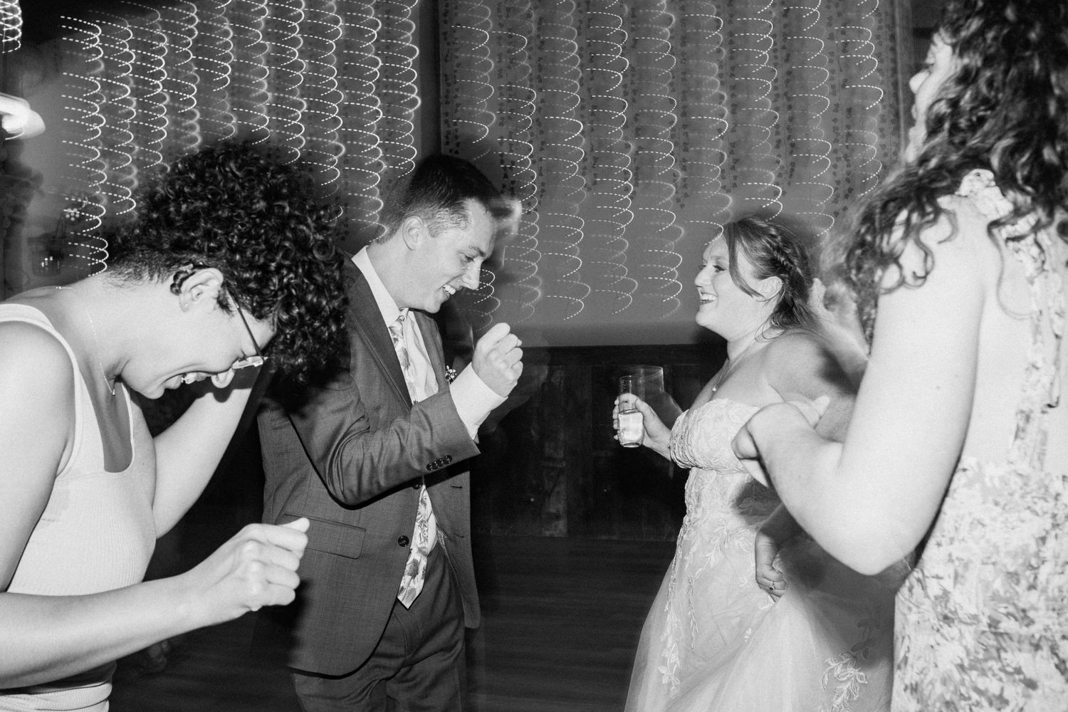 joyful couple dancing on full dance floor at missouri wedding venue