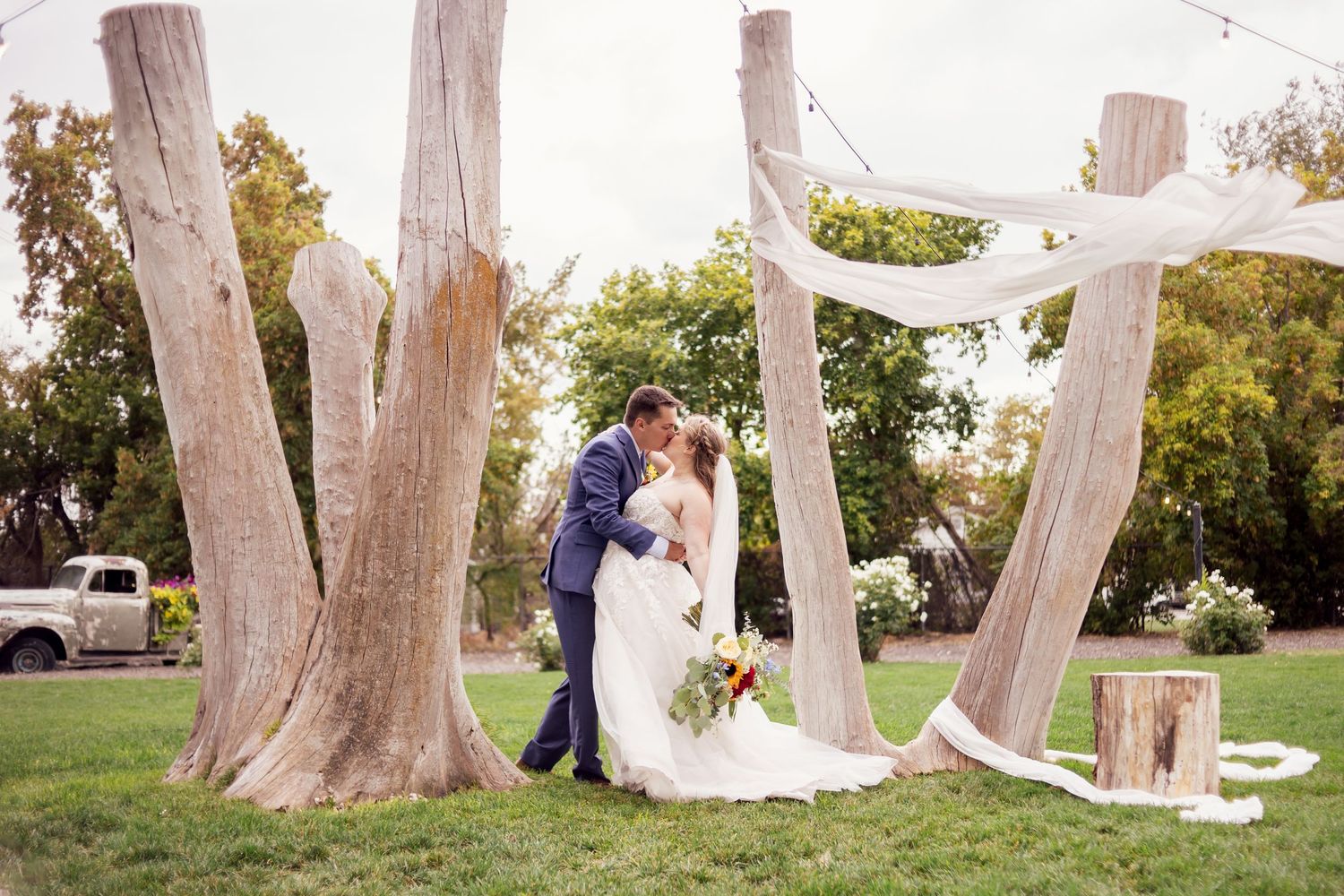 emotional kiss between bride and groom at outdoor missouri wedding ceremony
