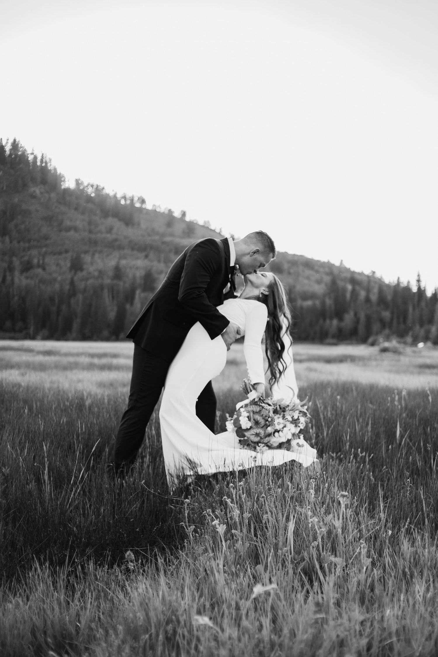 emotional kiss between bride and groom in missouri field