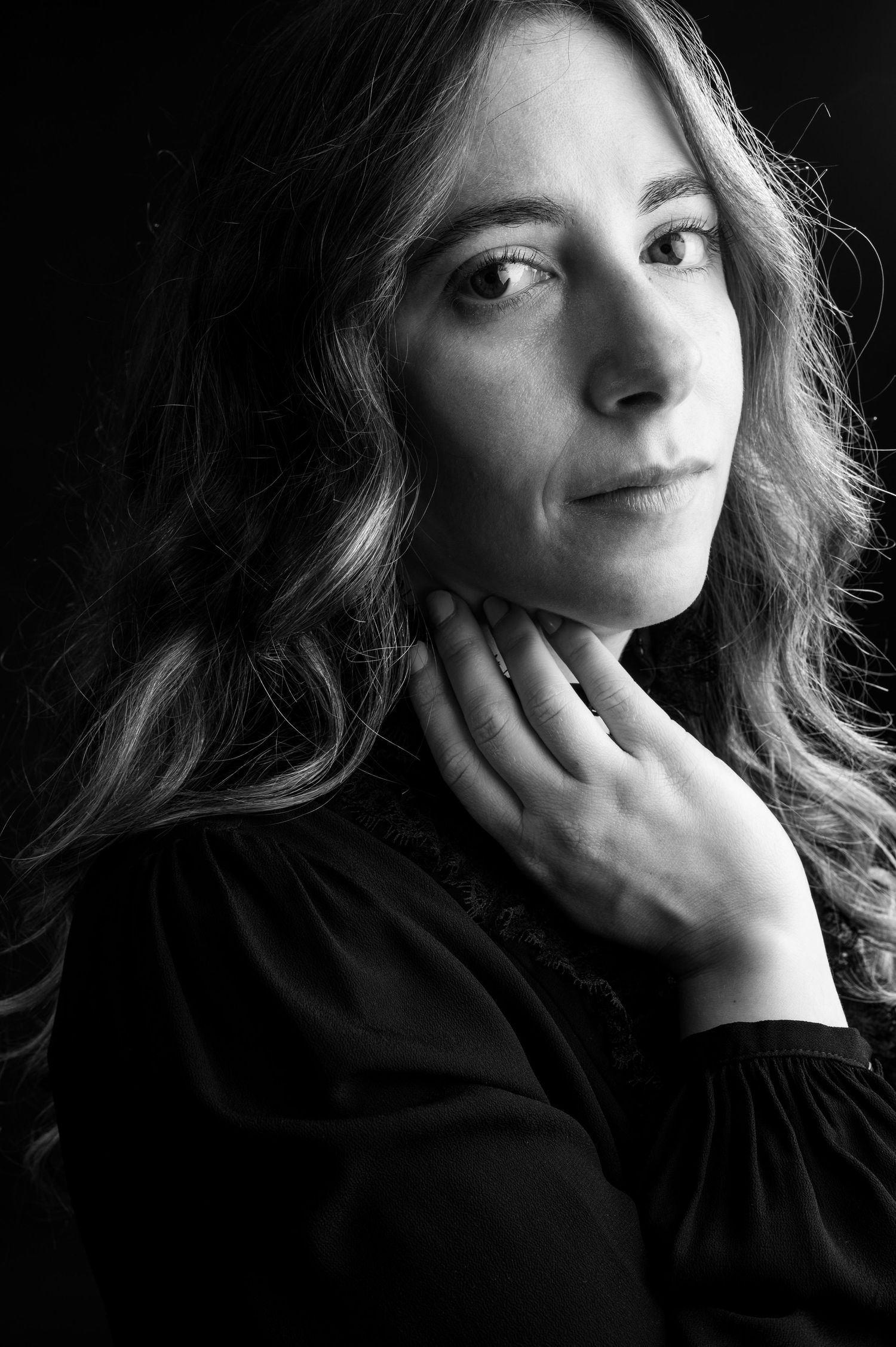A black and white portrait series showing artistic poses with dramatic lighting and shadows.