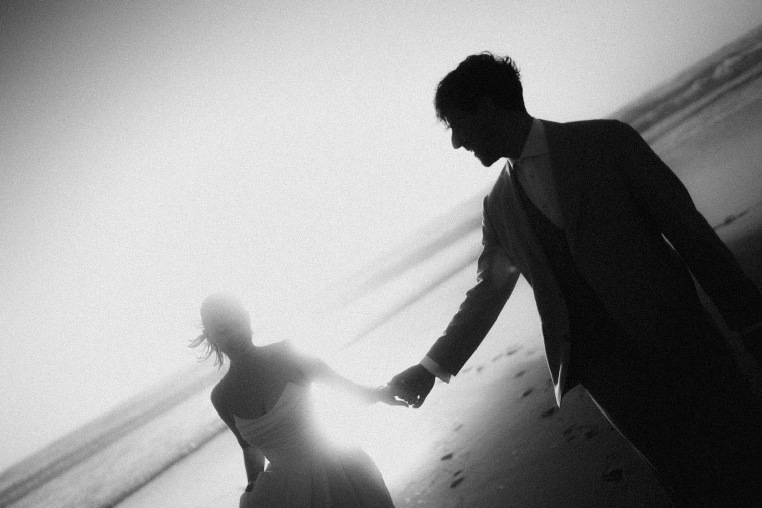 elopement couple holding hands by the sea in portugal