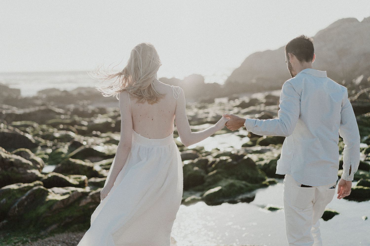 Couple walking together along the coast during a destination wedding in Portugal, captured in a natural and cinematic photography style.